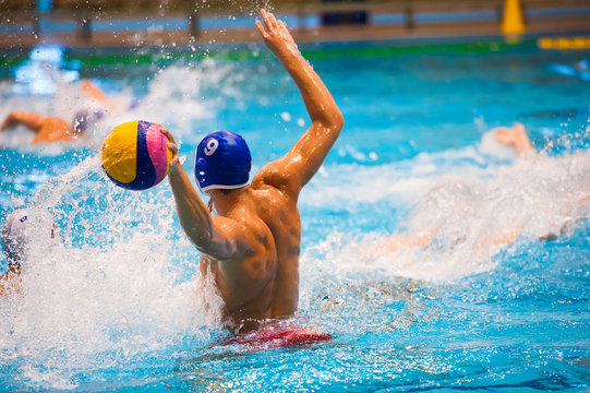 Water polo player winding up to shoot the ball