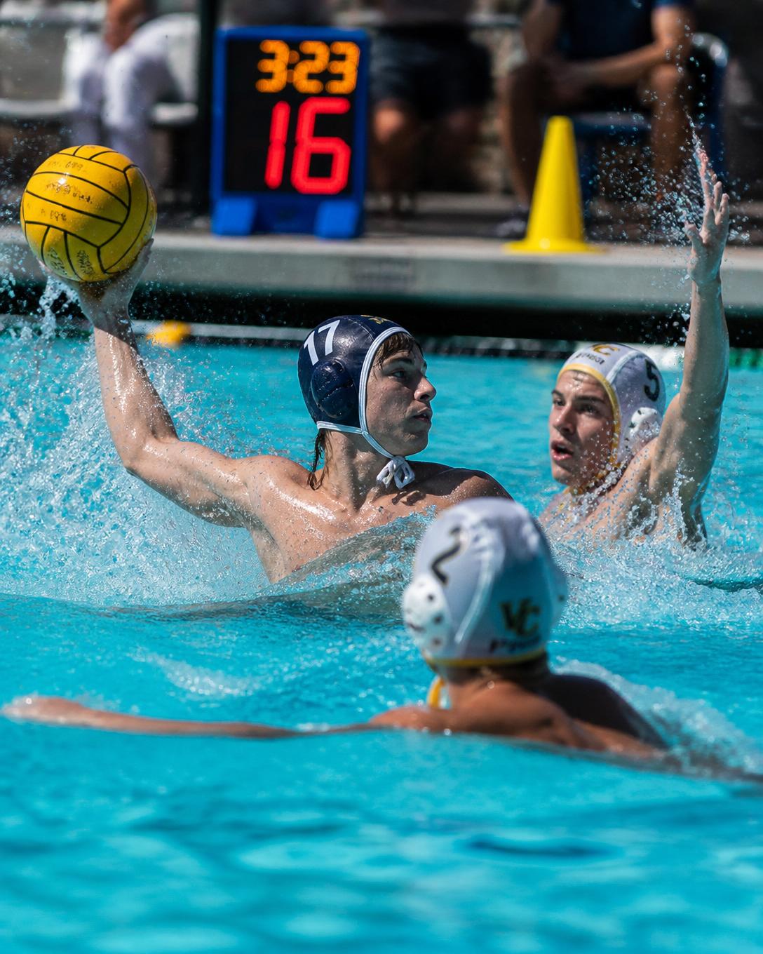 High school water polo players competing in an outdoor pool